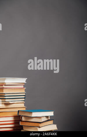 a lot of different educational books on a gray background Stock Photo