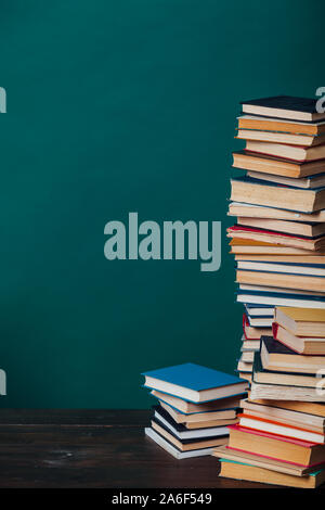 school a lot of different educational books on a green background Stock Photo