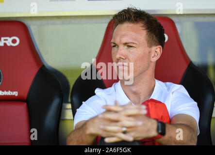 26 October 2019, Baden-Wuerttemberg, Freiburg: Soccer: Bundesliga, SC Freiburg - RB Leipzig, 9th matchday in the Schwarzwaldstadion. Coach Julian Nagelsmann from Leipzig sits on the bench. Photo: Patrick Seeger/dpa - IMPORTANT NOTE: In accordance with the requirements of the DFL Deutsche Fußball Liga or the DFB Deutscher Fußball-Bund, it is prohibited to use or have used photographs taken in the stadium and/or the match in the form of sequence images and/or video-like photo sequences. Stock Photo