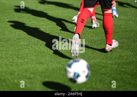 26 October 2019, Baden-Wuerttemberg, Freiburg: Soccer: Bundesliga, SC Freiburg - RB Leipzig, 9th matchday in the Schwarzwaldstadion. SC Freiburg players cast shadows on the lawn. Photo: Patrick Seeger/dpa - IMPORTANT NOTE: In accordance with the requirements of the DFL Deutsche Fußball Liga or the DFB Deutscher Fußball-Bund, it is prohibited to use or have used photographs taken in the stadium and/or the match in the form of sequence images and/or video-like photo sequences. Stock Photo