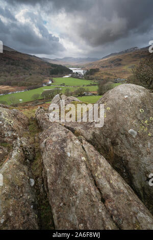 Winter landscape image of the view from Crimpiau and The Pinnacles towards Llynnau Mymbyr and snowcapped Snowdon in the distance Stock Photo