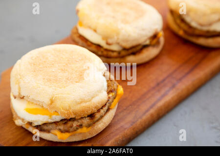 Homemade pork roll egg sandwich on a rustic wooden board on a gray surface, side view. Close-up. Stock Photo