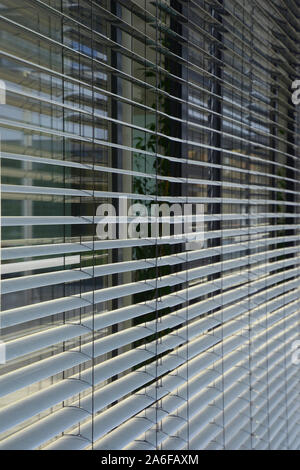 grey metallic outdoor window blinds, office window with modern exterior shutter Stock Photo