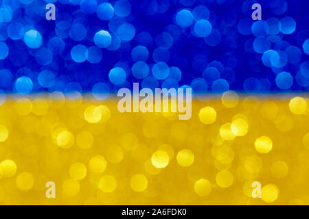 blue and yellow abstract patriotic background with bokeh, festive image with defocused glitter effect Stock Photo