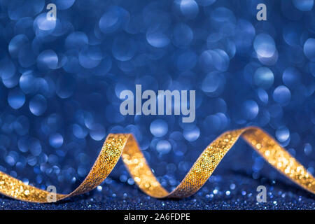 christmas background with golden ribbon and blue bokeh Stock Photo