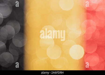 abstract patriotic bokeh background, black yellow and red glitter sparkle defocused background Stock Photo