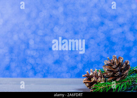 Christmas decoration with pine cone and fir tree on blue bokeh lights Stock Photo