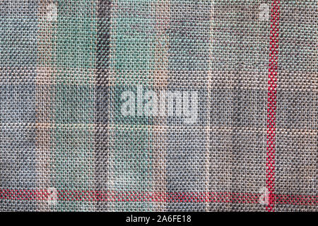 Close up of tartan material, showing coloured horizontal and vertical lines, and the woven texture of the material. Stock Photo