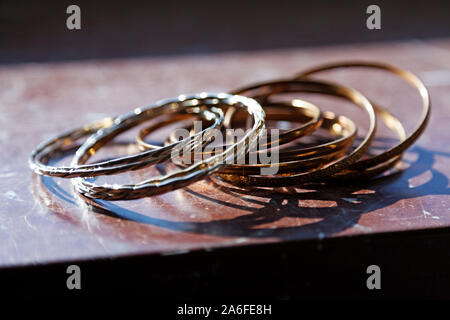 jewelery for the arm lying on a marble table under cold sunlight Stock Photo