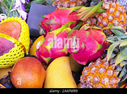 Mix of fresh exotic fruits such as dragon fruit, mango and pineapple. Stock Photo