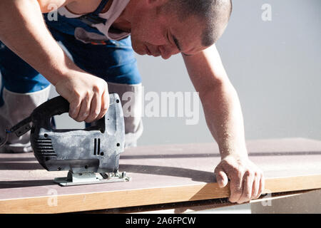 Closeup hand of carpenter woodworker with professional cutting