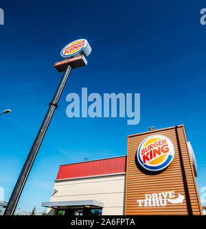 Madrid, Spain - Oct 26, 2019: Outside a fast-food Burger King restaurant with a sleek, contemporary futuristic industrial look includes brick cladding Stock Photo