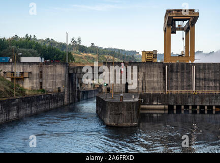 Filled lock as cruise boat leaves the Crestuma Lever dam on River Douro in Portugal Stock Photo