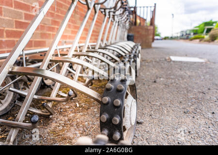 Golf carts for hire, ready for golfer to put their clubs on and go around the course Stock Photo