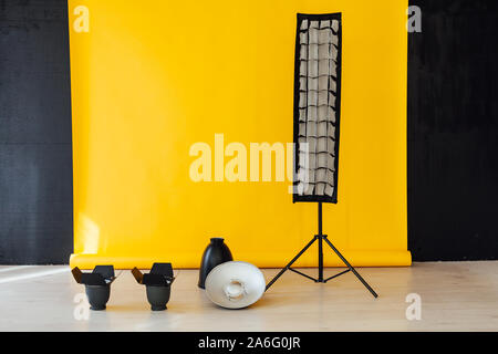 Flash equipment photo studio on yellow with black background Stock Photo