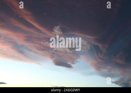 Colored clouds hovering in the sky during a Colorado Sunset Stock Photo