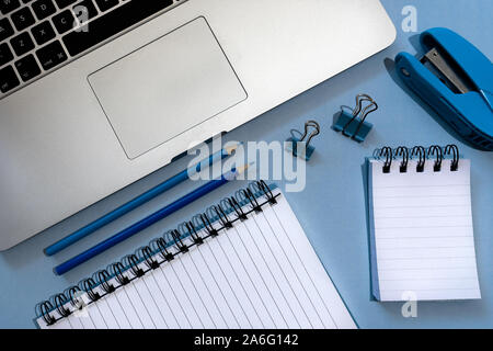 A Simple Desk Setup With Apple Macbook Laptop Note Pads Pencils