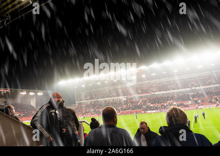 On a cold Tuesday night at Stoke City, as the rain comes down and soaks the players and fans during a home match at the BET365 Stadium, Stoke City FC Stock Photo