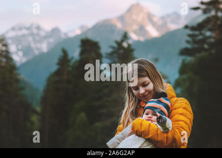 Mother hiking with baby travel family vacations in mountains healthy lifestyle outdoor parenthood maternity summer trip Stock Photo