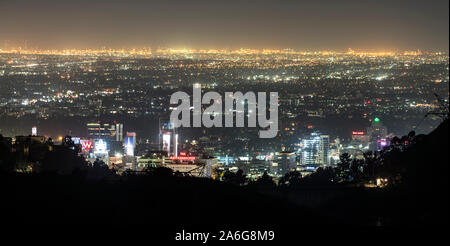 Los Angeles, California, USA - October 24, 2019:  Night panorama view of downtown Hollywood towers from hilltop ridge near popular Griffith Park.  The Stock Photo
