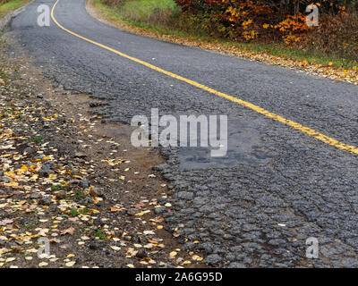 Quebec,Canada. A crumbling asphalt road in Rawdon. Stock Photo