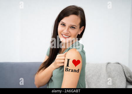 Woman Showing Her I Love Brand Tattoo Stock Photo
