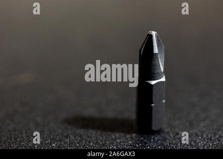Phillips magnetic drill bit stainless steel, isolated on a black textured background Stock Photo