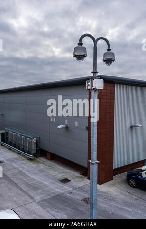 CCTV cameras overlooking a factory car park in the poverty stricken district of the city Stock Photo