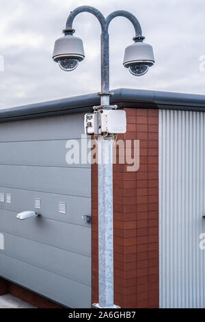 CCTV cameras overlooking a factory car park in the poverty stricken district of the city Stock Photo
