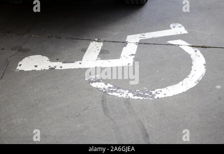 Parking for the disabled on the road, symbol and background Stock Photo