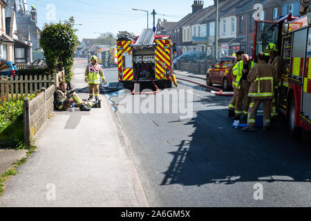 Firefighters attend an emergency scene, with a house on fire in Clacton on Sea, Washing machine, tumble dryer cause Stock Photo