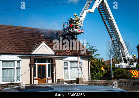 Firefighters attend an emergency scene, with a house on fire in Clacton on Sea, Washing machine, tumble dryer cause Stock Photo