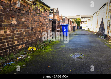 Discarded rubbish and overflowing bins in the back streets of Fenton, Stoke in Trent, recycling, bin collections, poor deprived area, neglected Stock Photo