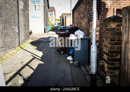 Discarded rubbish and overflowing bins in the back streets of Fenton, Stoke in Trent, recycling, bin collections, poor deprived area, neglected Stock Photo