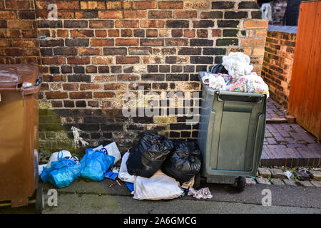 Discarded rubbish and overflowing bins in the back streets of Fenton, Stoke in Trent, recycling, bin collections, poor deprived area, neglected Stock Photo