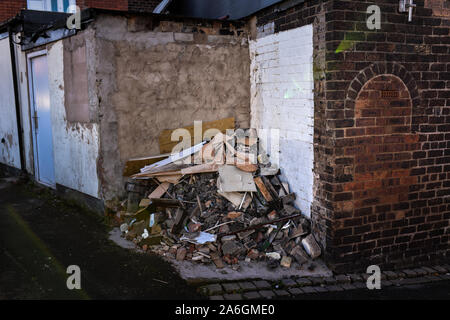 Discarded rubbish and overflowing bins in the back streets of Fenton, Stoke in Trent, recycling, bin collections, poor deprived area, neglected Stock Photo