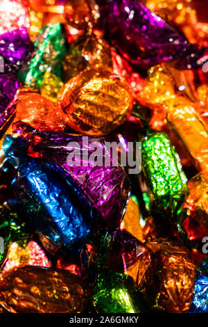 A selection of quality street chocolates in a tin ready to be eaten, Christmas time, festive treats Stock Photo