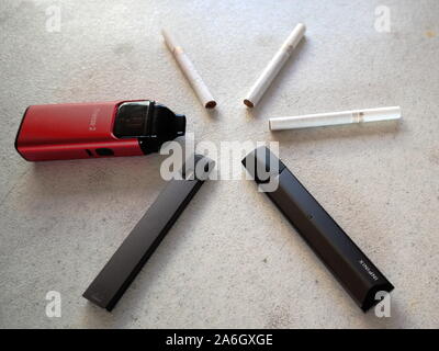 3 vape electronic cigarette juul, aspire breeze, smok inifinix devices and  3 marlboro gold light cigarettes in a star pattern on a white textured back  Stock Photo - Alamy