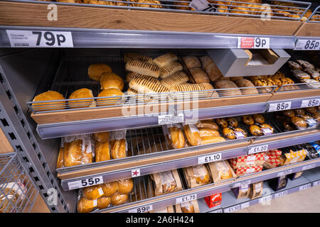 A selection of rolls, baps and baguettes and other bread products fresh in the Tesco extra store, shop Stock Photo
