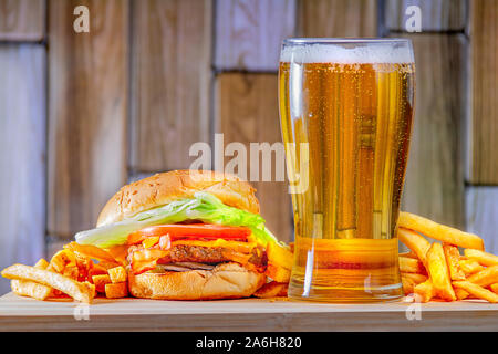 Beer and french fries on a wooden plate Stock Photo