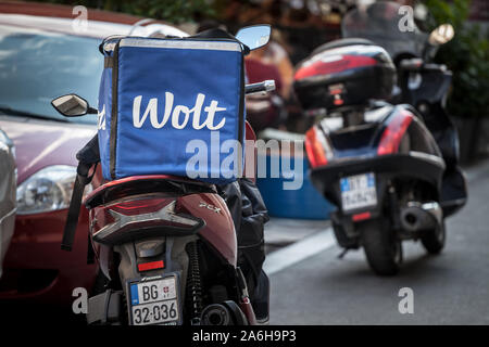 BELGRADE, SERBIA - SEPTEMBER 14, 2019: Wolt logo on the bag of a delivery man on his scooter in belgrade. Wolt is a Finnish Food delivery app spread i Stock Photo