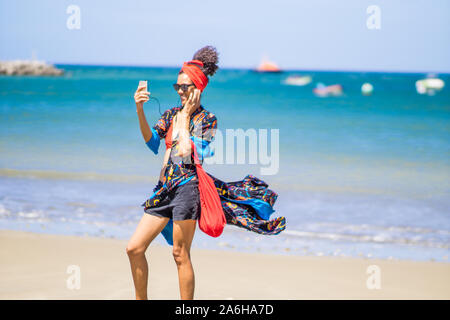 lose up of a young African American woman at the beach taking selfie Stock Photo