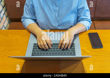 High angle view photo of woman hand typing laptop keyboard Stock Photo