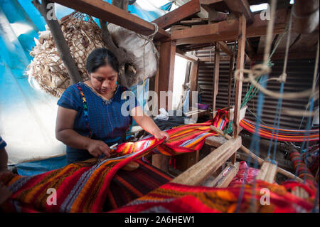 A maya indigenous woman weaves  on a leg loom in San Antonio Palopo. Stock Photo