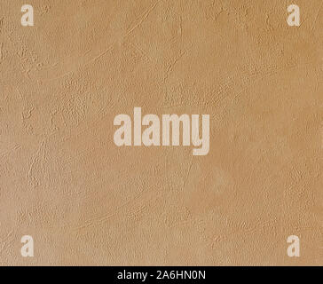 Bright beige rough plastered house wall frame as a background Stock Photo