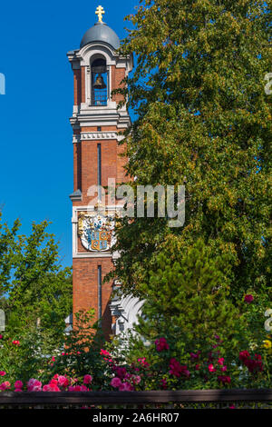 View of the Belarusian Mir castle complex made of red brick against a bright blue sky on a sunny day Stock Photo