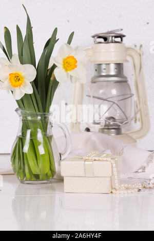 Still life with spring flowers and a kerosene lamp Stock Photo