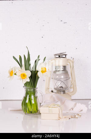 Still life with spring flowers and a kerosene lamp Stock Photo