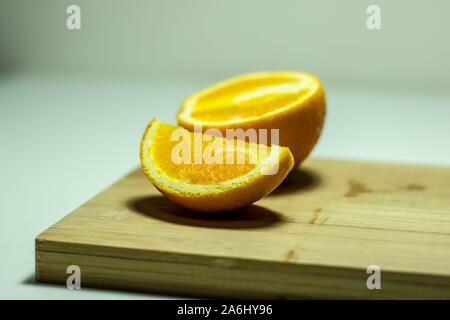 Large oranges cut on a chopping block Stock Photo