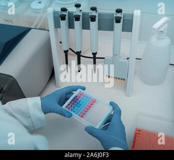 Woman in latex gloves holding samples for researching in hands Stock Photo